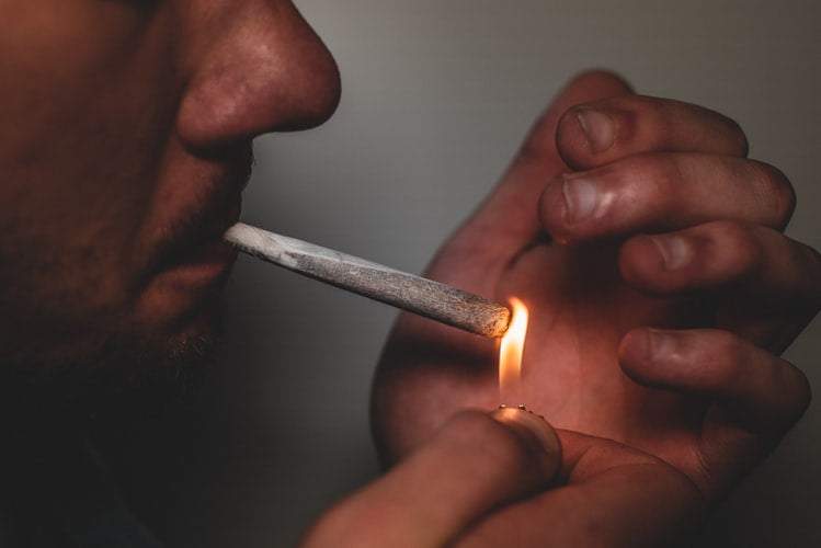 A man lighting a joint 