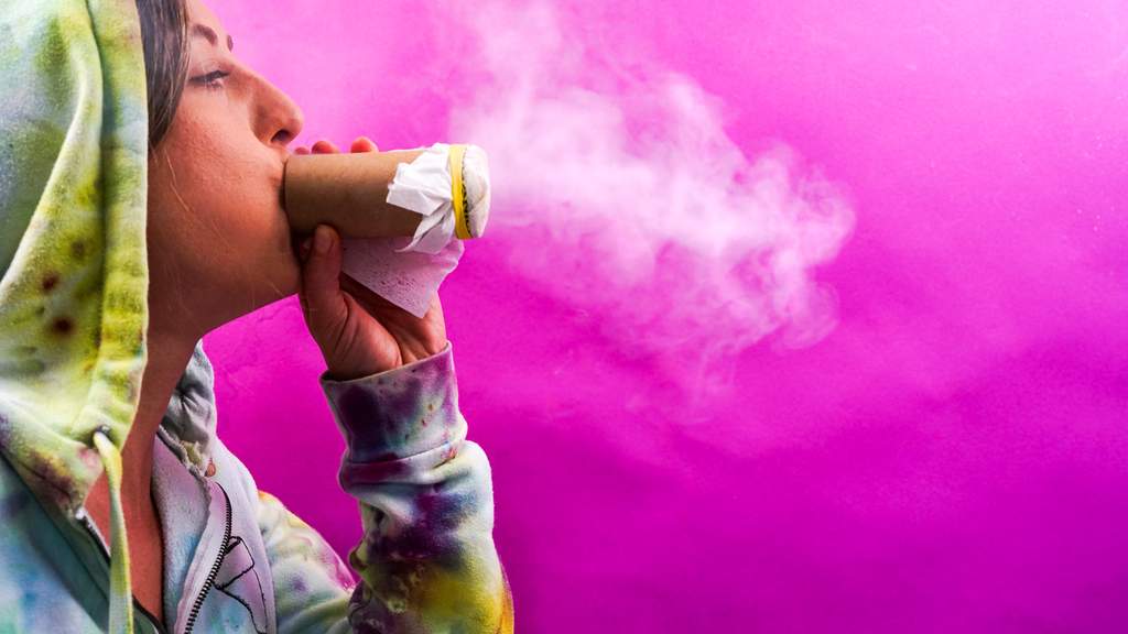 stoner blowing smoke through a homemade sploof to filter marijuana smell