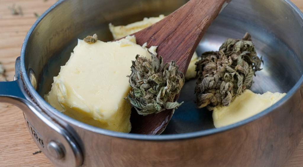 cannabis and butter in a saucer pan to make cannabutter on the stove