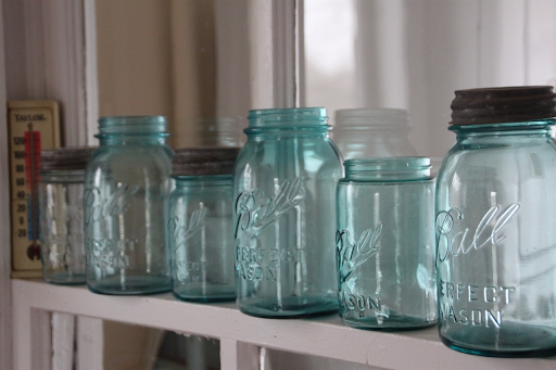An arrangement of light blue mason jars, which can be used for the green dragon recipe.