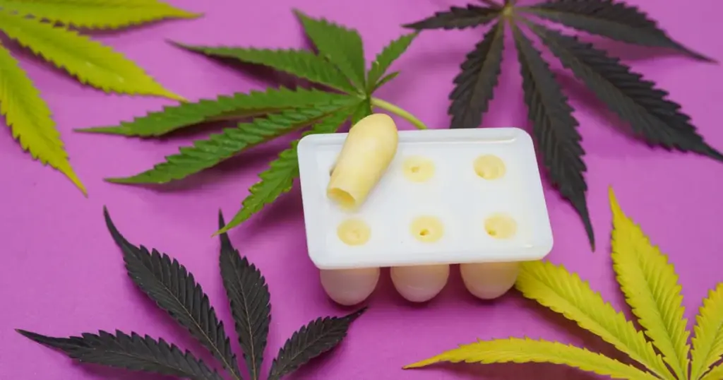 DIY cannabis suppositories setting in a silicone mold, using natural cocoa butter and full-extract cannabis oil for homemade pelvic pain relief.